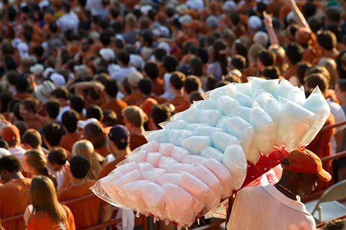 Vendor selling cotton candy amongst the spectators