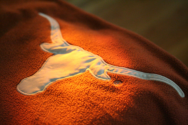 Longhorn logo on a blanket, lit by ray of sunlight.