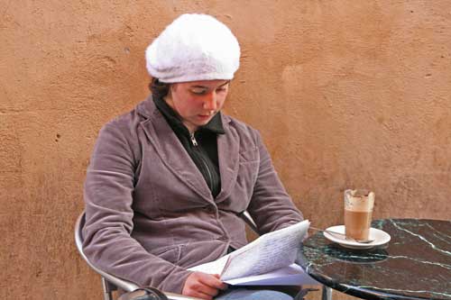 Woman drinking latte at sidewalk cafe in Roma